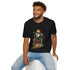 A man sits on a white block, smiling, wearing a black T-shirt with a graphic of a skeleton in a cowboy outfit smoking a cigar and holding a bag of money, with a stack of bitcoin coins