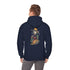 A man stands wearing a navy blue hoodie with a graphic of a skeleton in a cowboy outfit smoking a cigar and holding a bag of money, with a stack of bitcoin coins on the back side of the hoodie.